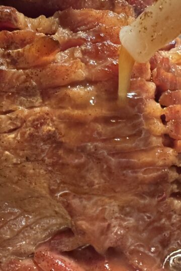 A Sliced Ham being basted
