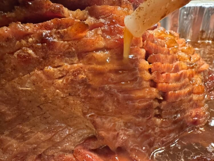 A Sliced Ham being basted