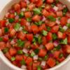 a bowl of fresh tomatoes onion and peppers called pico de gallo