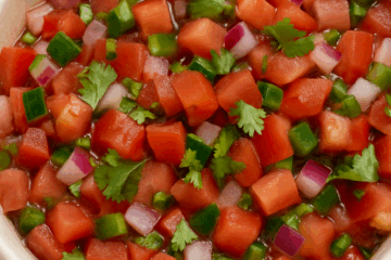 a bowl of fresh tomatoes onion and peppers called pico de gallo