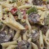 overhead closeup shrimp and penne pasta with sprinkles of parmesan cheese