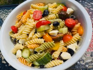 tri color rotini pasta salad with olives feta cheese tomato and cucumber
