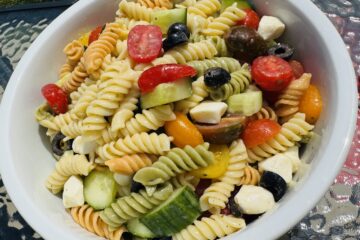 tri color rotini pasta salad with olives feta cheese tomato and cucumber