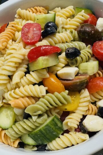 tri color rotini pasta salad with olives feta cheese tomato and cucumber