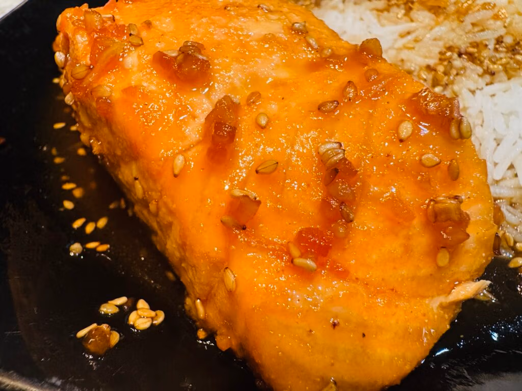 a portion of teriyaki salmon with sesame seeds