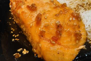 a portion of teriyaki salmon with sesame seeds