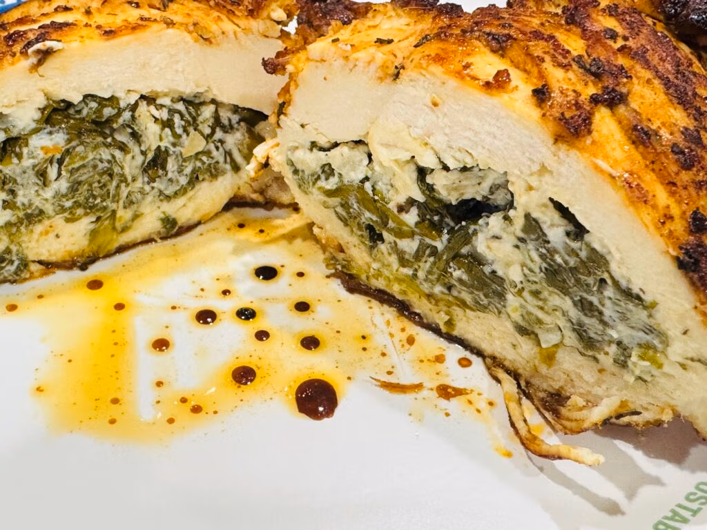 Perfectly stuffed chicken breast cross sectioned to show spinach and goat cheese