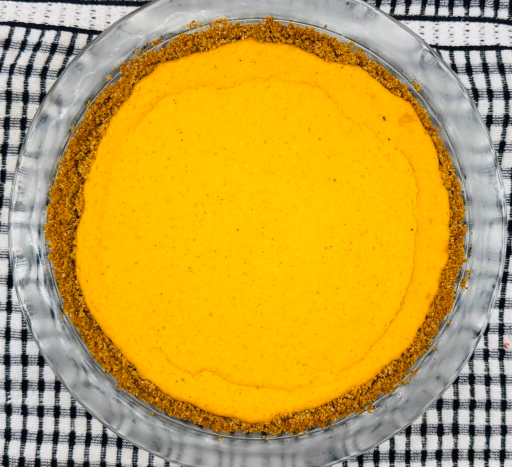 A top down view of a graham cracker crust pumpkin cheesecake