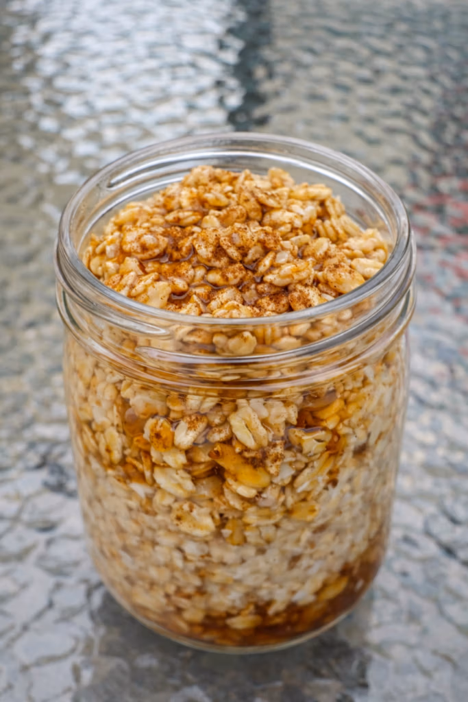 a mason jar of brown sugar overnight oats with maple syrup

